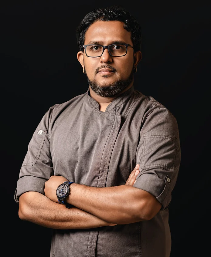 Chef Manju preparing dishes at Spark Chef Dining & Takeout